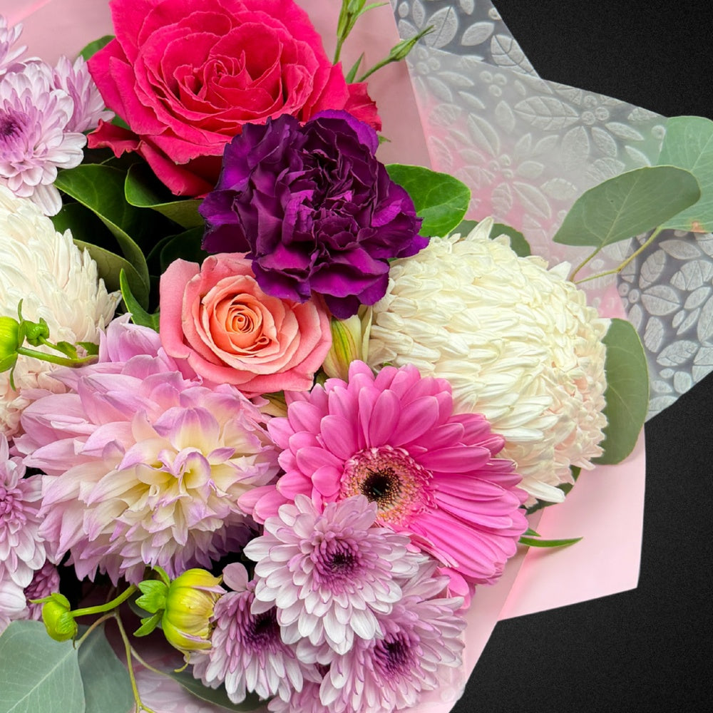 Close-up of a soft pastel Rose and Carnation bloom within 'The Everlasting Embrace' Mother's Day bouquet, showcasing delicate textures.