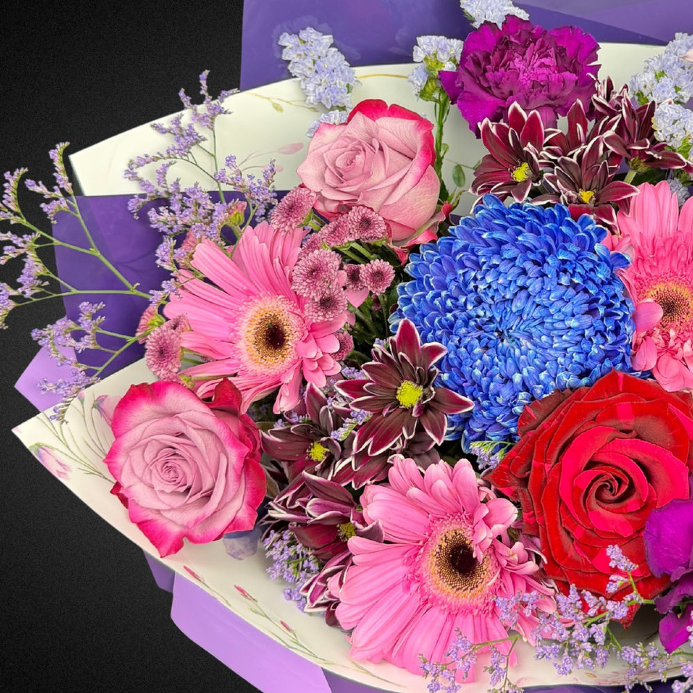 Close-up view of the fresh, premium Roses, Chrysanthemums, and Dahlias in the Mother's Day Radiance Bouquet, showcasing the intricate details and 'Mixed Brights' color palette.
