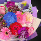 Close-up view of the fresh, premium Roses, Chrysanthemums, and Dahlias in the Mother's Day Radiance Bouquet, showcasing the intricate details and 'Mixed Brights' color palette.