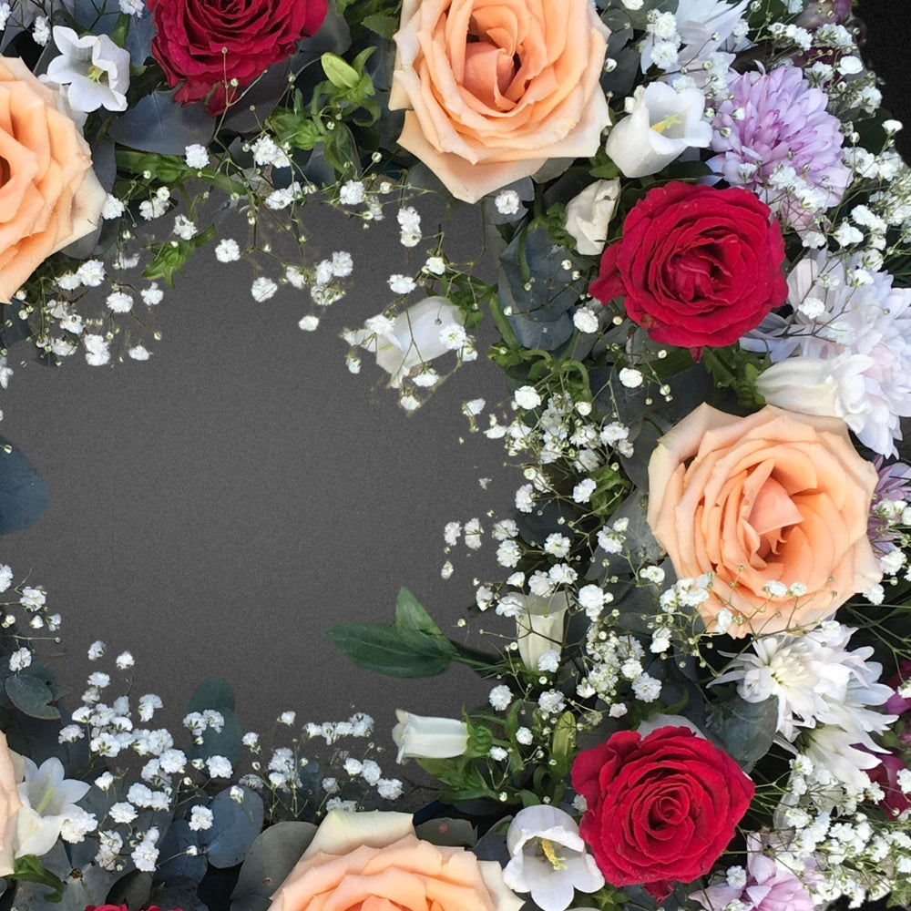 Close-up detail of the artisan craftsmanship of the FLOWER SHED Brisbane wreath, showcasing the realistic textures and bright colours of the faux rose, chrysanthemum, and lisianthus flowers.